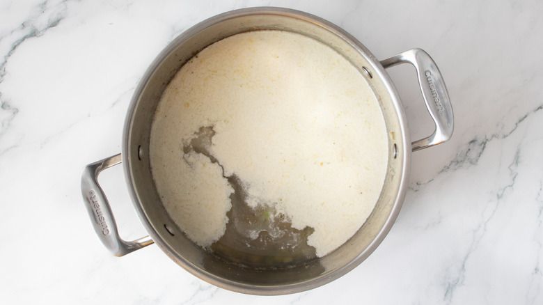 white and clear liquids in a metal pot