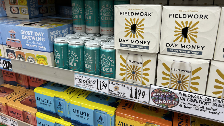 Several nonalcoholic beer varieties on a store shelf.