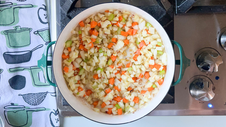Aromatic vegetables cooking in pot on stove