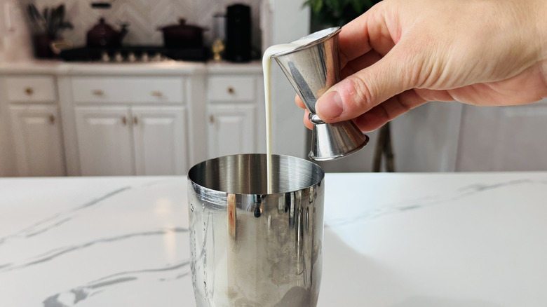 Pouring cream into a cocktail shaker