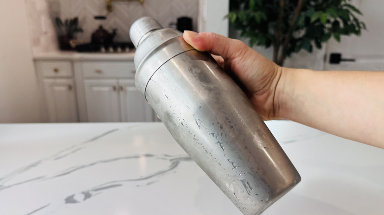 Hand shaking a cocktail shaker