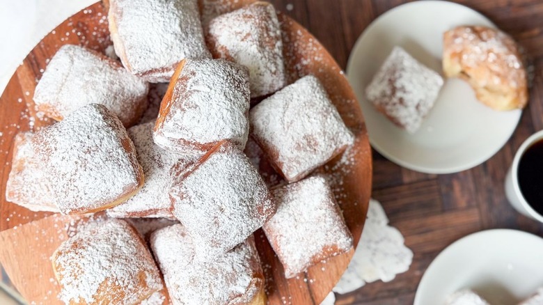 Classic sugar-coated beignets on cake stand
