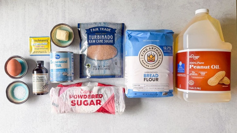 Classic sugar-coated beignets ingredients on countertop