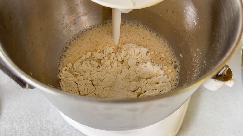 Mixing beignet dough with dough hook in stand mixer bowl