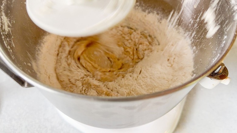 Mixing beignet dough in stand mixer bowl with dough hook