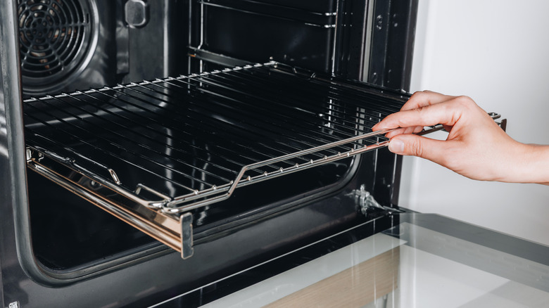 An opened oven revealing a clean rack.