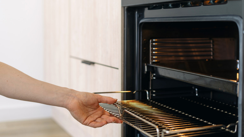 Woman opening oven