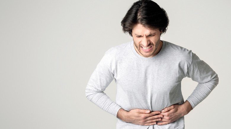 An individual experiencing acute stomach pain.