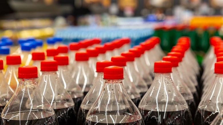 Rows of soda bottles with only the top portions of the bottles showing
