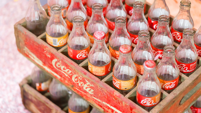 Vintage Coca-Cola bottles in a branded wooden crate