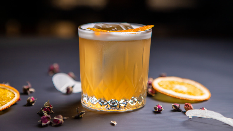Whiskey sour surrounded by orange slices