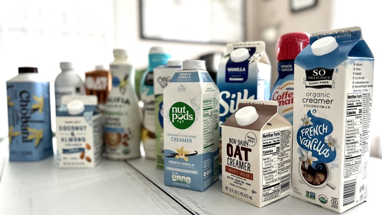12 types of coffee creamers arranged on countertop