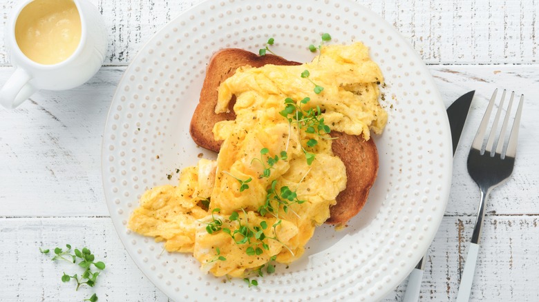 scrambled eggs with toast on plate