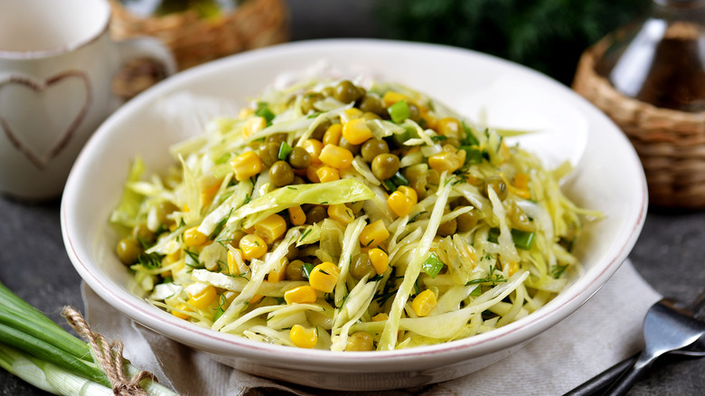 cabbage and sweet corn slaw in a white bowl