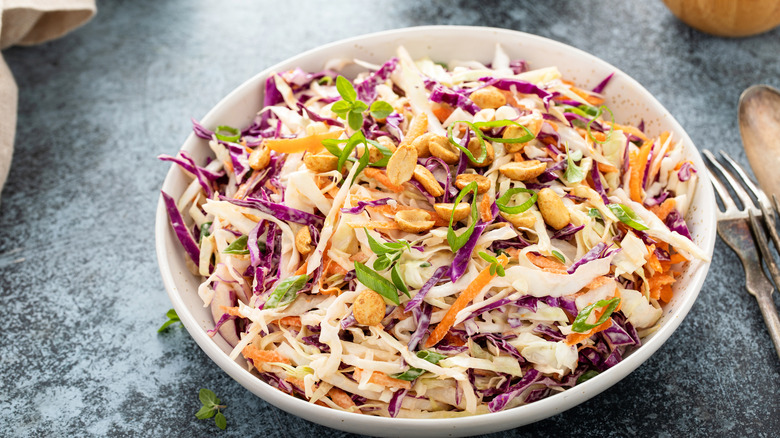 Bowl of coleslaw with peanuts