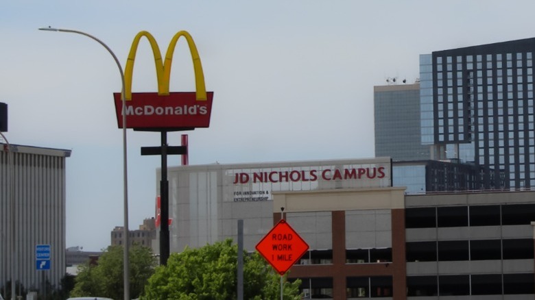 A sign for McDonald's next to a campus building for the JD Nichols campus in Louisville, Kentucky.