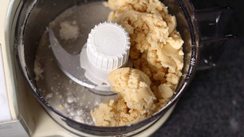 Pie dough ingredients in a food processor.