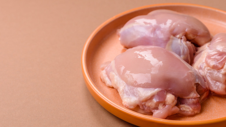 Chicken thighs on a plate.