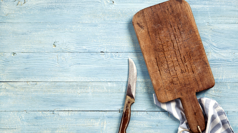 Cracked cutting board with knife