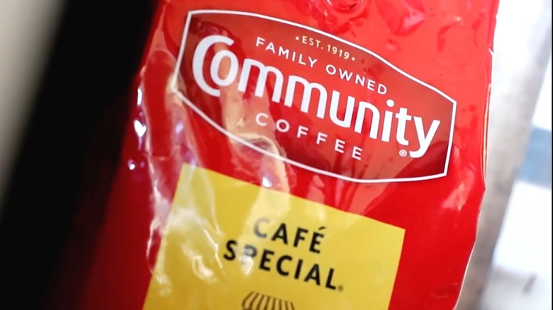A package of Community Coffee is shiny and red