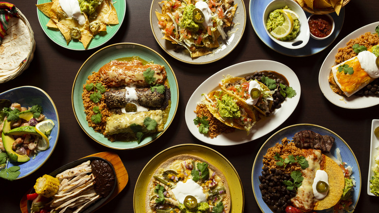 A colorful flat lay of various Mexican foods, arranged neatly on their plates.