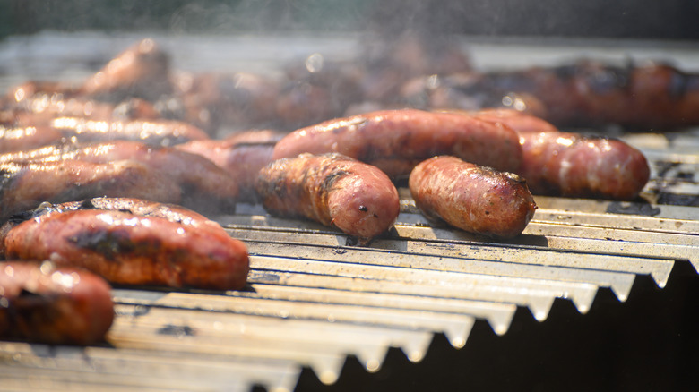 Juicy sausages cooking on a grill