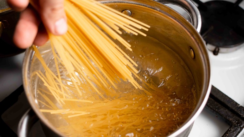 Adding spaghetti to boiling water