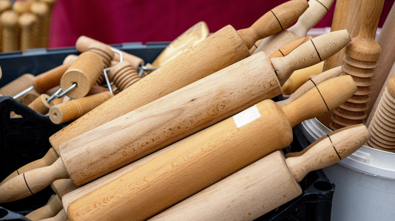 basket with a pile of wooden rolling pins inside