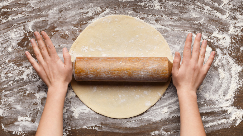 overhead view of rolling dough with a rolling pin