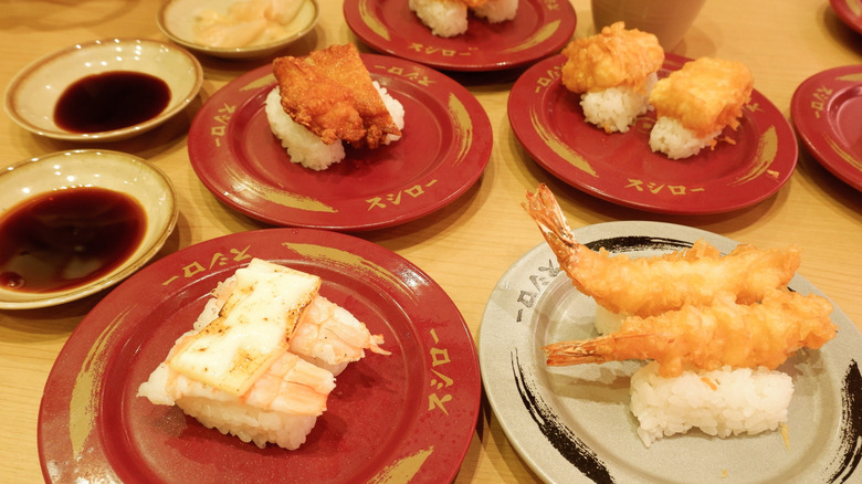Small plates containing different types of sushi