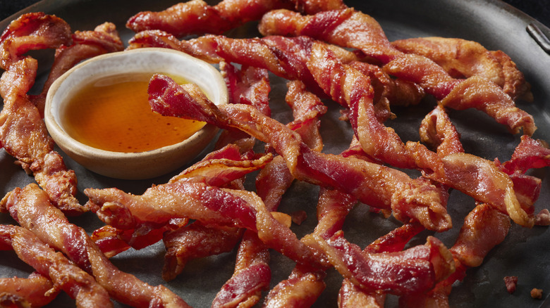 Twisted bacon strips with maple syrup.