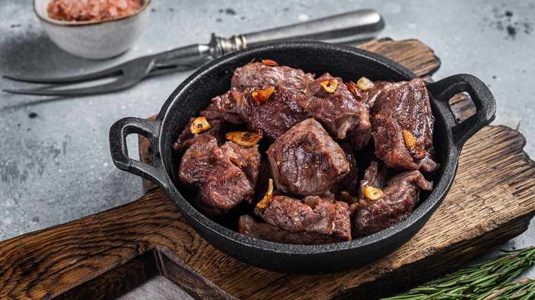 Diced steak chunks in cast iron pan