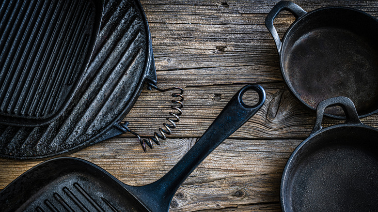 Array of cast iron pans on counter