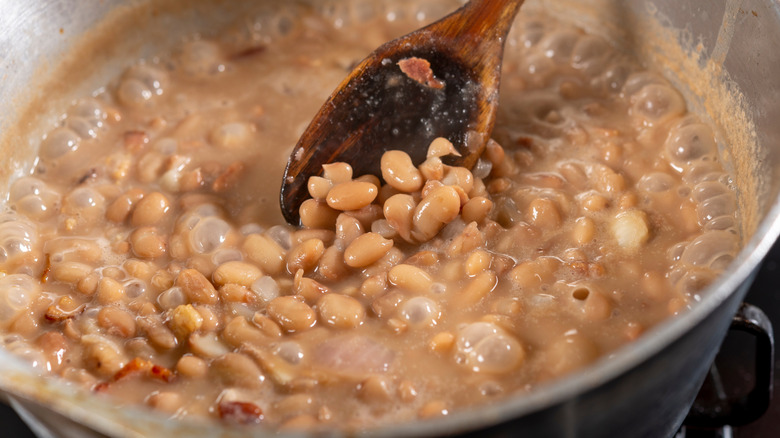 Cooking beans in a saucepan on the stove in the kitchen.