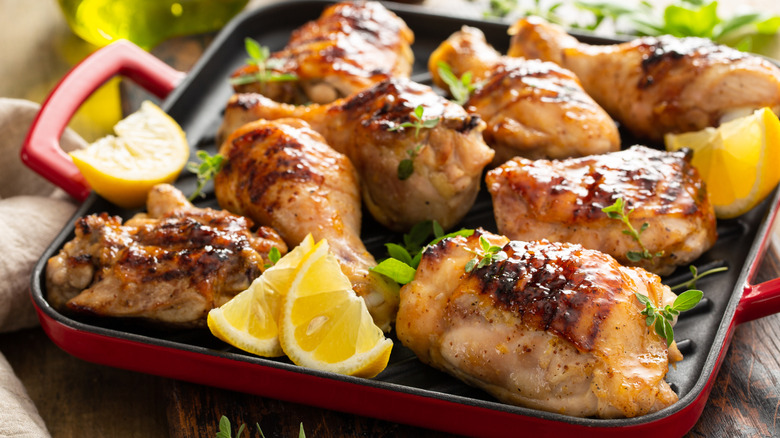 Grilled chicken and lemons in a cast iron pan