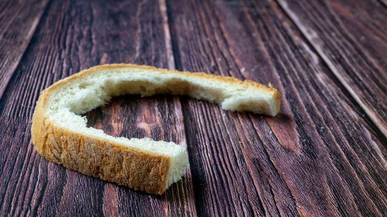 A slice of bread that has been mostly eaten, leaving only the crust