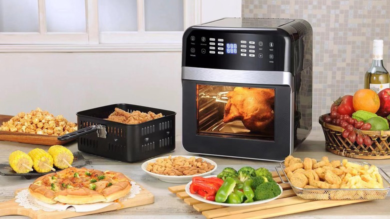 Air fryer surrounded by food