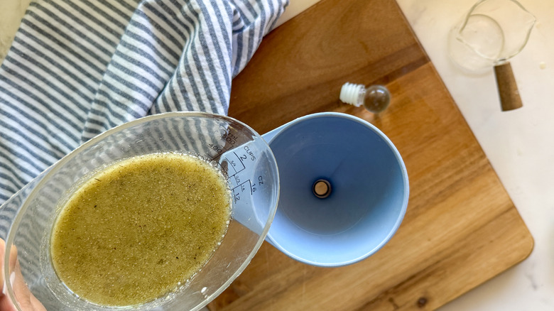 pouring dressing into a funnel