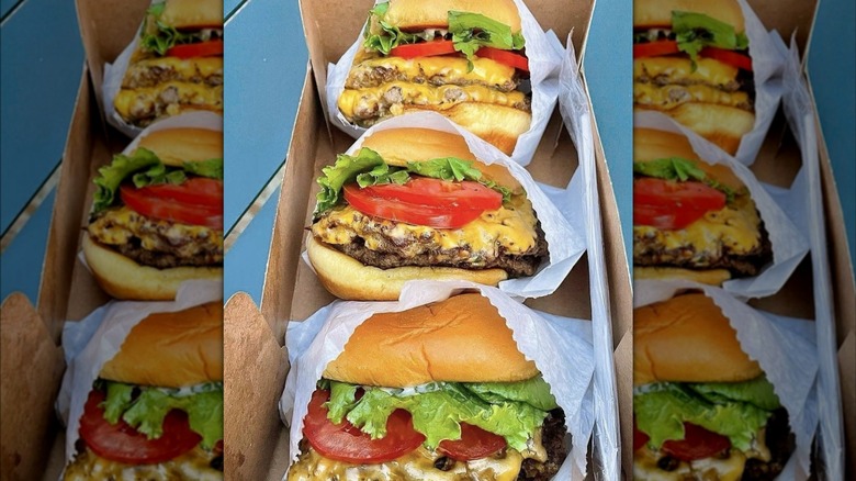 Paper-wrapped Shake Shack burgers in a tray