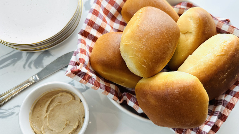 rolls in a basket with a red-checked napkin