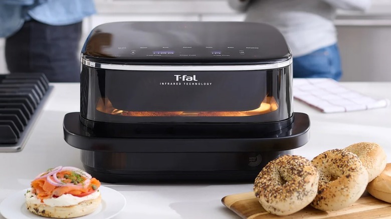 T-fal Infrared Air Fryer on a counter, with bagels on the side
