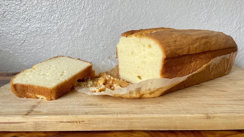 Costco's All Butter Pound Cake on a cutting board with a large slice taken out