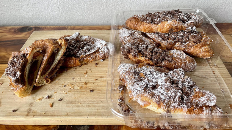 Package of Costco's Twice Baked Chocolate Filled Croissants with one sliced in half