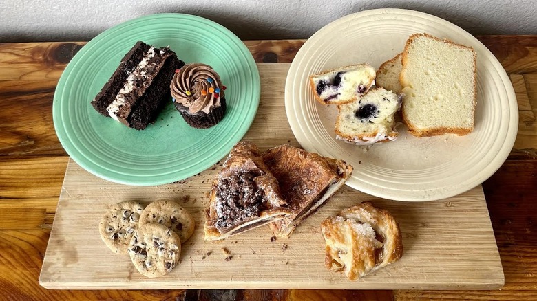 Assorted Costco desserts on plates and a cutting board