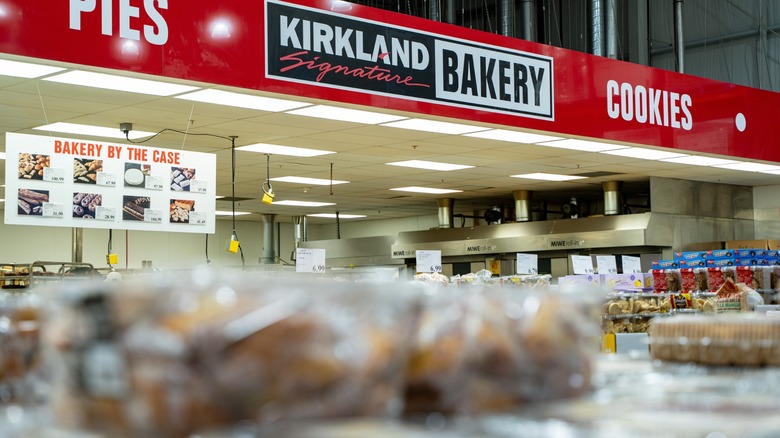 A photo of Costco's Kirkland Signature Bakery features shelves full of various baked goods.
