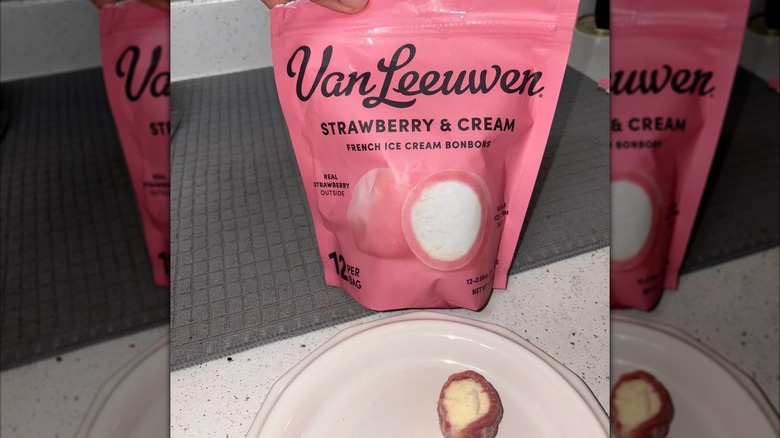 A pink Van Leeuwen branded container filled strawberry and ice cream bonbons
