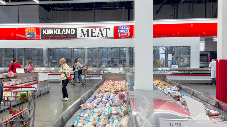 People shopping in the Costco meat department