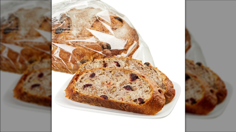 Sliced Kirkland cranberry walnut round bread in plastic packet.
