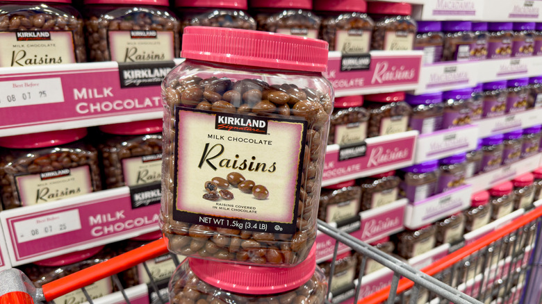 A view of several containers of Kirkland Signature milk chocolate raisins, at Costco