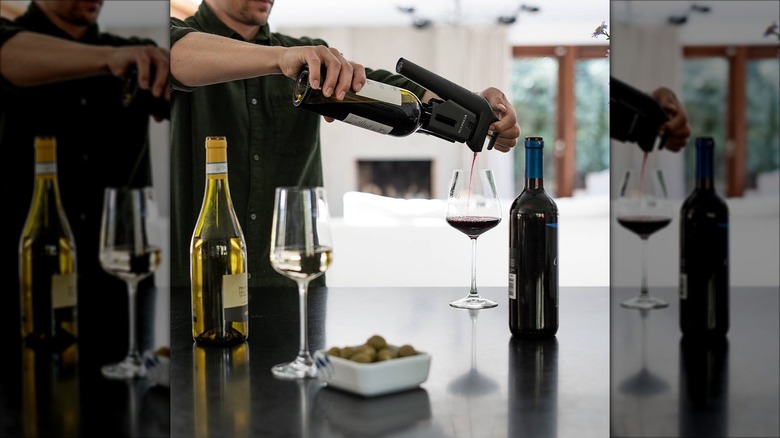 Person using the Coravin Timeless Three 4-piece wine preservation system
